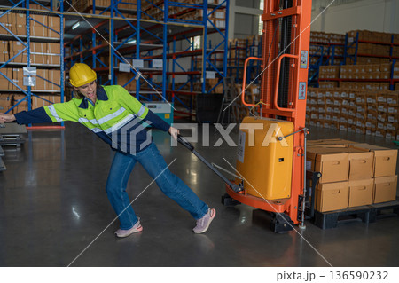 Warehouse worker working in warehouse storage.  136590232