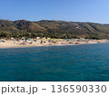 Beautiful panoramic view of the Calabrian coast during the summer season, featuring turquoise crystal-clear waters, dramatic rocky cliffs, and charming seaside scenery under bright blue skies. The 136590330
