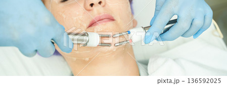 Female receiving facial skin treatment with electrotherapy at spa Female receiving facial skin treatment with electrotherapy at spa 136592025