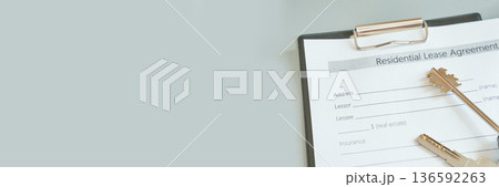 Close-up of residential lease agreement with keys on clipboard 136592263