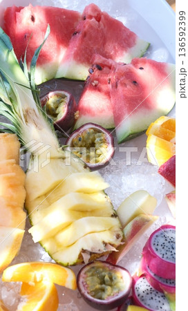 A tasty fruit salad on top of clear ice 136592399