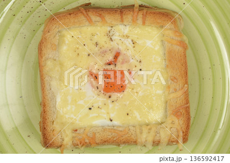 Baked toast with egg and melted cheese on a green plate Baked toast with egg and melted cheese on a green plate 136592417