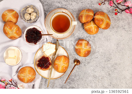 Festive Easter treat. Easter buns are decorated with a cross, jam, butter, and cherry blossoms. English buns are baked on Friday and served with tea the morning before Easter Sunday. 136592561