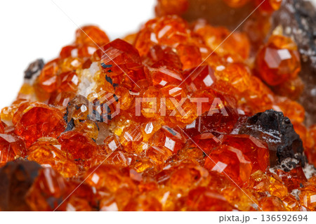 macro mineral stone Spessartine, orange, red garnet with quartz on white background macro mineral stone Spessartine, orange, red garnet with quartz on white background 136592694