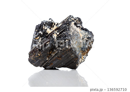 macro mineral stone sherle, schorl, black tourmaline on white background macro mineral stone sherle, schorl, black tourmaline on white background 136592710