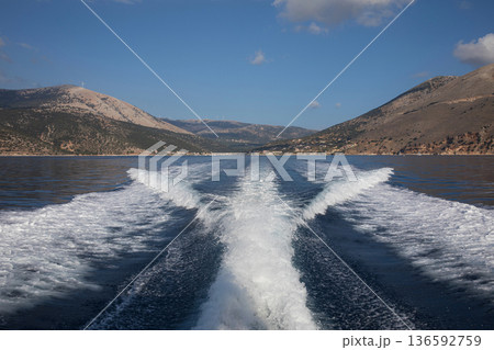 Traveling by sea on a yacht from the AGIA EFIMIA marina, KEFALONIA Island, Ionian Islands, Greece in the summer morning. Horizontal. Traveling by sea on a yacht from the AGIA EFIMIA marina, KEFALONIA Island, Ionian Islands, Greece in the summer morning. Horizontal. 136592759