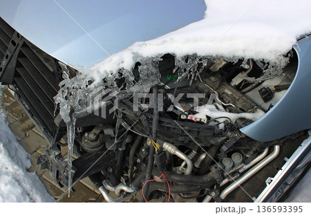 Icicles Frozen On The Disassembled Front Part Of A Damaged Car Icicles Frozen On The Disassembled Front Part Of A Damaged Car 136593395