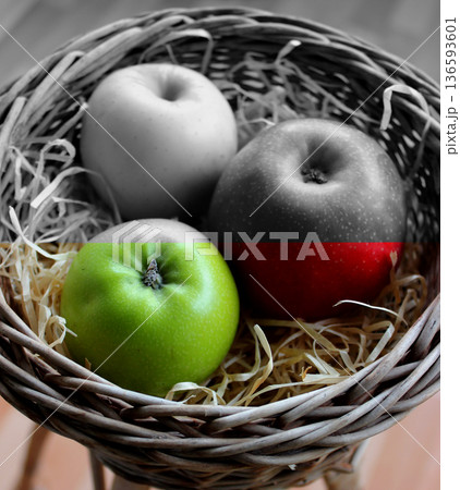 Handmade Basket Filled with Wood Shavings and Whole Apples Variety Types on It Split in Color Stock Image. Healthy and Unhealthy Fruits Concept Photo 136593601
