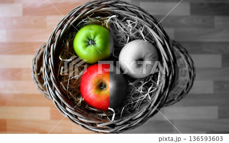 Color Split Image of a Colorful Apples Lie in Woven Basket. Fertilizers for Apples Maturation and Storage Concept Photo Color Split Image of a Colorful Apples Lie in Woven Basket. Fertilizers for Apples Maturation and Storage Concept Photo 136593603