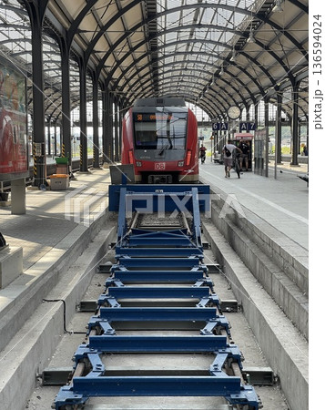 Red train standing on station platform in wiesbaden 136594024