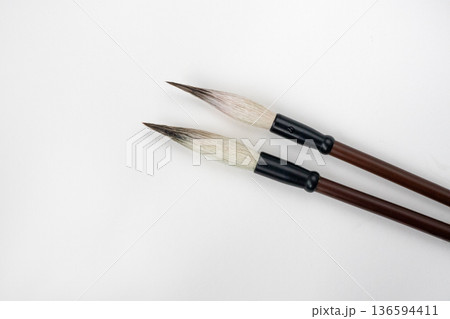 Two writing brushes, pens for writing Chinese traditional calligraphy. Traditional writing brushes isolated on white background 136594411
