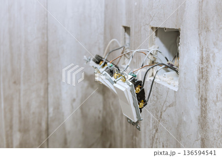 Wiring installation process in room with exposed wall electrical outlets 136594541