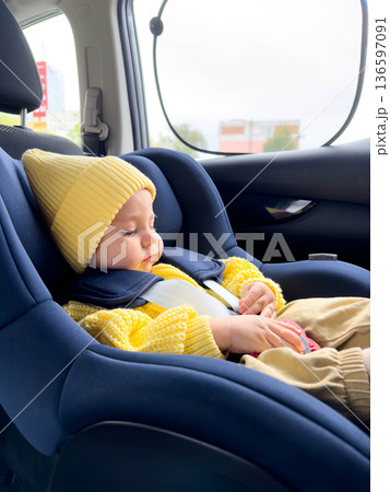 Smiling Baby in Car Seat with Yellow Sweater and Hat Smiling Baby in Car Seat with Yellow Sweater and Hat 136597091