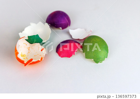 Colorful cracked easter egg shells on white background with copy space. Soft focus Colorful cracked easter egg shells on white background with copy space. Soft focus 136597373