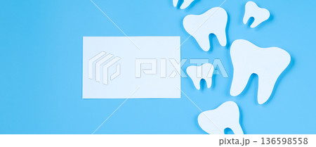 Paper cut mockup of tooth on blue background. Dental care concept. International Dentist Day. Paper cut mockup of tooth on blue background. Dental care concept. International Dentist Day. 136598558