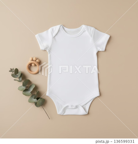 Clean white baby bodysuit flat lay mockup with wooden teether and eucalyptus branch on neutral beige background. 136599331
