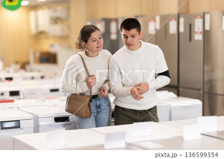 Young couple choosing washing machine or dishwasher 136599354