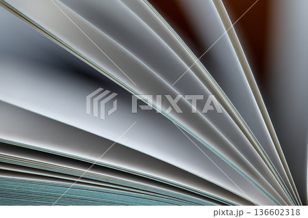 High-angle macro shot of fanned out book pages creating a rhythmic geometric pattern of light and shadow High-angle macro shot of fanned out book pages creating a rhythmic geometric pattern of light and shadow 136602318