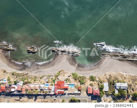 Drone view of a coastal area with rocks and houses near the water 136602441