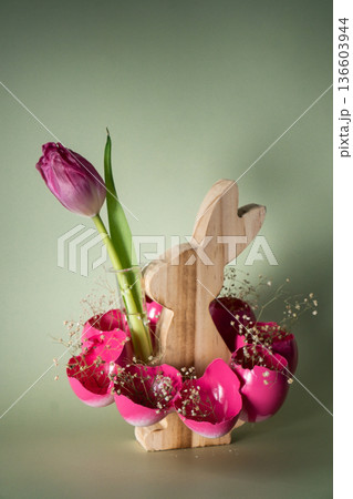Easter holiday decoration from sustainable materials pink colored egg shell wooden bunny vase decor with fresh tulip flower. Copy space Diy do it yourself Gift present idea. Zero waste Crafting Easter holiday decoration from sustainable materials pink colored egg shell wooden bunny vase decor with fresh tulip flower. Copy space Diy do it yourself Gift present idea. Zero waste Crafting 136603944