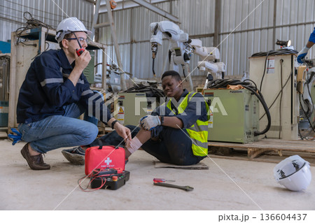 First aid support accident at work of worker at factory. First aid support accident at work of worker at factory. 136604437
