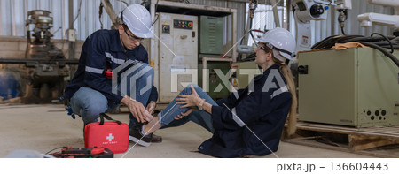 First aid support accident at work of worker at factory.  136604443