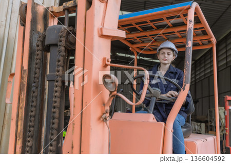 Woman worker at forklift driver happy working in industry factory logistic ship. Woman worker at forklift driver happy working in industry factory logistic ship. 136604592