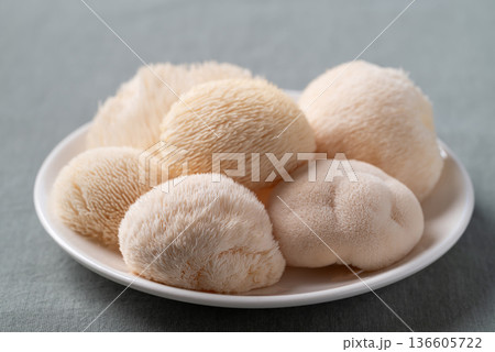 Fresh Lion's Mane mushroom (Hericium erinaceus) on a white plate 136605722
