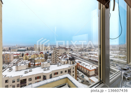 Snowy Winter Cityscape View from Modern Apartment Window 136607436