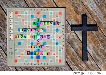 Scrabble Board With Colorful Words Next To A Dark Cross Scrabble Board With Colorful Words Next To A Dark Cross 136607872