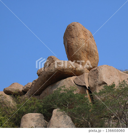 Heavy round granite boulder appearing like a easter egg. Sanapur, village near Hampi, India. 136608060