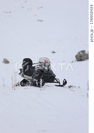 Snowy snowmobile solitude. High quality photo 136608484
