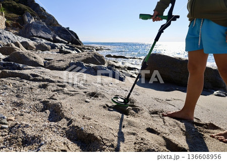 Beach metal detecting. High quality photo 136608956