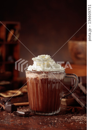 Hot chocolate with whipped cream in a glass mug. 136609751