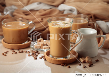 Latte with brown sugar on a beige background. 136609756