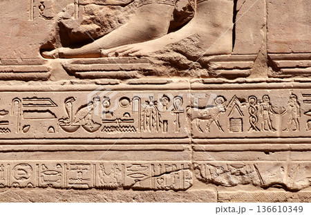 Ancient Egyptian hieroglyphs on stone wall, Karnak Temple Complex, Luxor, Egypt, Africa. Stone carvings with hieroglyphs at Karnak temple complex, Thebes Ancient Egyptian hieroglyphs on stone wall, Karnak Temple Complex, Luxor, Egypt, Africa. Stone carvings with hieroglyphs at Karnak temple complex, Thebes 136610349