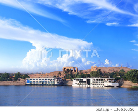 View from cruise ship on Nile river and Kom Ombo Temple, Egypt, Africa. Luxury Nile Cruise. Summer vacation, relaxing on cruise ship. Famous tourist attraction. Topic of travel, trip, cruises and tour View from cruise ship on Nile river and Kom Ombo Temple, Egypt, Africa. Luxury Nile Cruise. Summer vacation, relaxing on cruise ship. Famous tourist attraction. Topic of travel, trip, cruises and tour 136610350