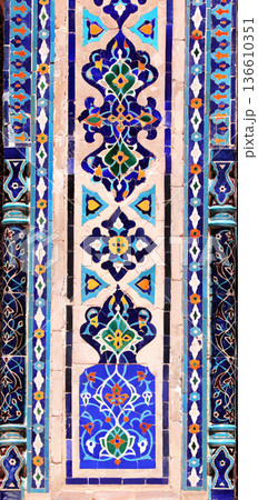 Vertical background with detail of ancient mosaic walls with floral and geometric ornament. Traditional tile decoration on wall, Samarkand, Uzbekistan 136610351
