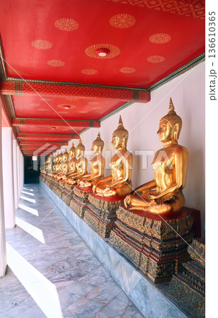 A row of seated Buddhas at Wat Pho complex, sightseeing landmark of Bangkok, Thailand. Golden Buddha statues at Wat Phra Chetuphon. Topic of vacation, travel, trip, cruises, tour A row of seated Buddhas at Wat Pho complex, sightseeing landmark of Bangkok, Thailand. Golden Buddha statues at Wat Phra Chetuphon. Topic of vacation, travel, trip, cruises, tour 136610365