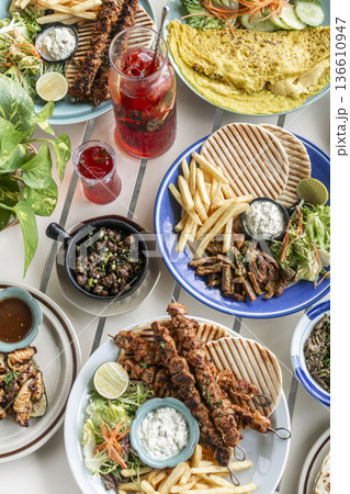 many different mediterranean food dishes on restaurant table in greece 136610947