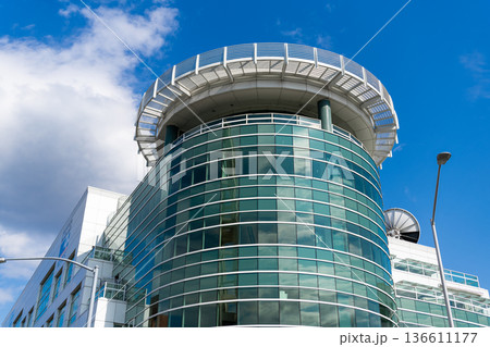Glass tower building. Architectural design of building. Residential building architecture. Architectural exterior detail. Residential exterior fragment. Modern residential building 136611177