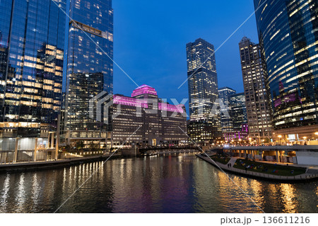 Chicago architecture of skyscraper at river. City night illuminated building. Skyscraper cityscape. Night city of Chicago, Illinois. Business city. Night cityscape of Chicago skyscraper building Chicago architecture of skyscraper at river. City night illuminated building. Skyscraper cityscape. Night city of Chicago, Illinois. Business city. Night cityscape of Chicago skyscraper building 136611216