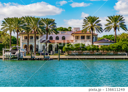 Waterfront landscape with house. Vacation in summer. Luxury waterfront hotel building. Summer vacation. Landscape with luxury residential area. Residential waterfront apartment. Palm tree 136611249
