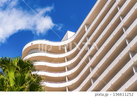 Architectural exterior detail. Residential building exterior. Modern apartment building. Hotel building architecture. Residential building multistory architecture Architectural exterior detail. Residential building exterior. Modern apartment building. Hotel building architecture. Residential building multistory architecture 136611252