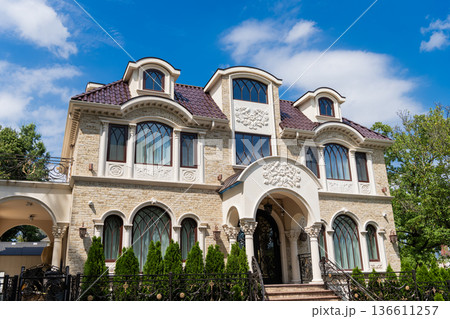 Suburb exterior with housing property. Suburban neighborhood. Private family home property. House exterior architecture. Private house in suburban area. Suburban house architecture. House exterior 136611257