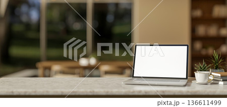 Blank screen laptop and coffee with book and pot plant on marble table in living room or dining room Blank screen laptop and coffee with book and pot plant on marble table in living room or dining room 136611499