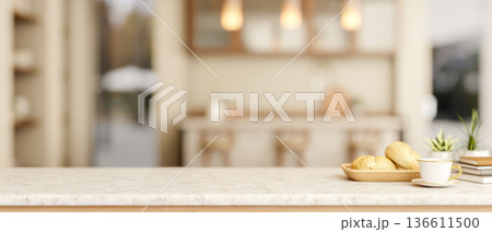 Coffee cup with breads on marble table across counter bar and cupboard in a kitchen or dining room. 136611500