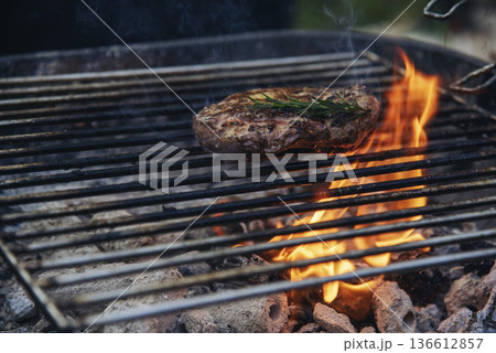 BBQ Barbecue grilled meat stick on fire flame with hot charcoal cooking outside. Beef grilling picnic outdoor with smoke bacon spicy sausage for party. Grill pork bbq on fire flame 136612857