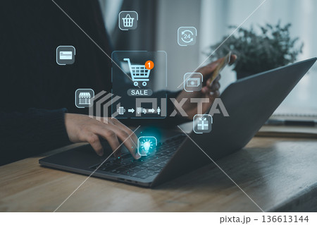 Person Using Smartphone and Laptop for Online Shopping with Sale Notifications and Digital Icons Presenting E-commerce and Technology Concepts Person Using Smartphone and Laptop for Online Shopping with Sale Notifications and Digital Icons Presenting E-commerce and Technology Concepts 136613144