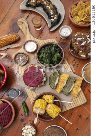 mixed colombian and venezuelan food meal spread on wooden restaurant table mixed colombian and venezuelan food meal spread on wooden restaurant table 136613160